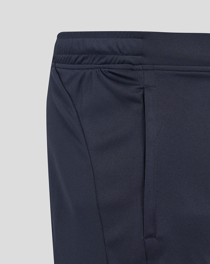 Back and side view of navy knit rugby shorts with teal side panel and elastic waistband.