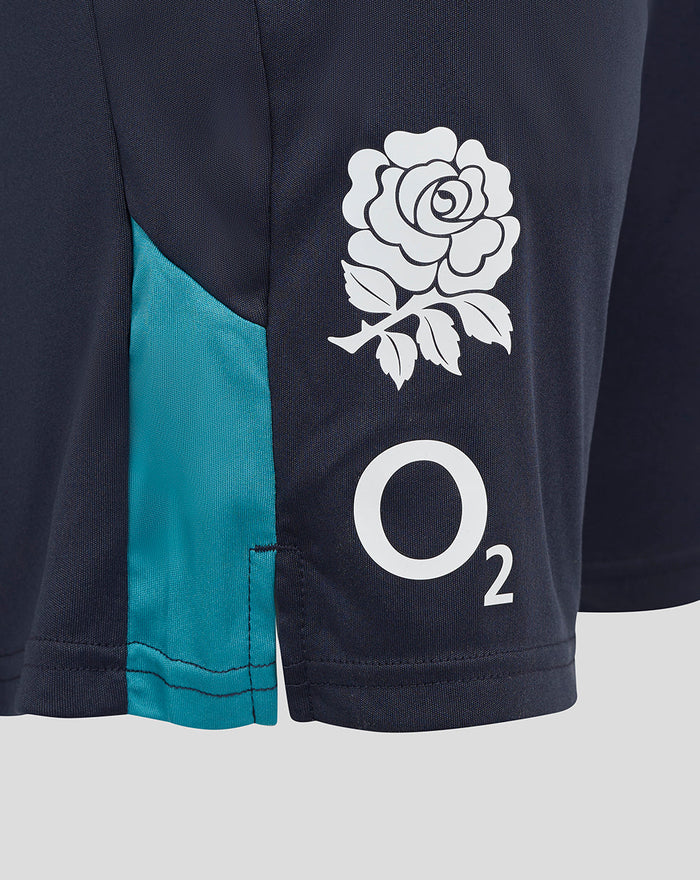 Close-up of navy England rugby shorts showing white rose crest on the thigh and teal side panel.