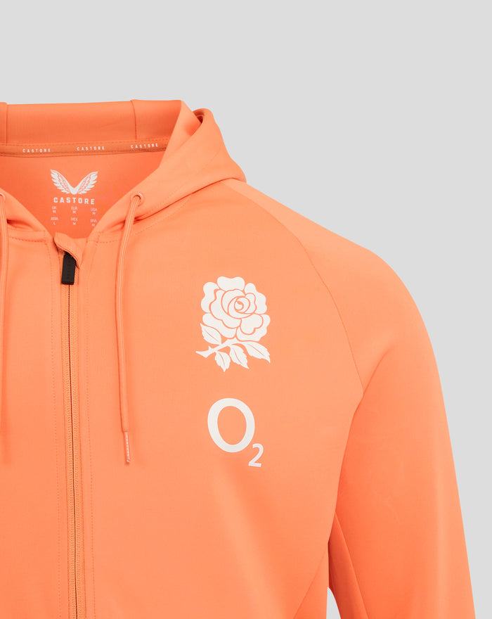 Chest area of melon hoodie featuring large white rose graphic and O2 logo on bright orange fabric