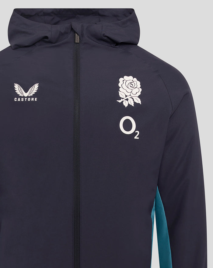 Close-up of navy shower jacket displaying Castore logo on left chest a rose crest on the right chest and O2 branding.