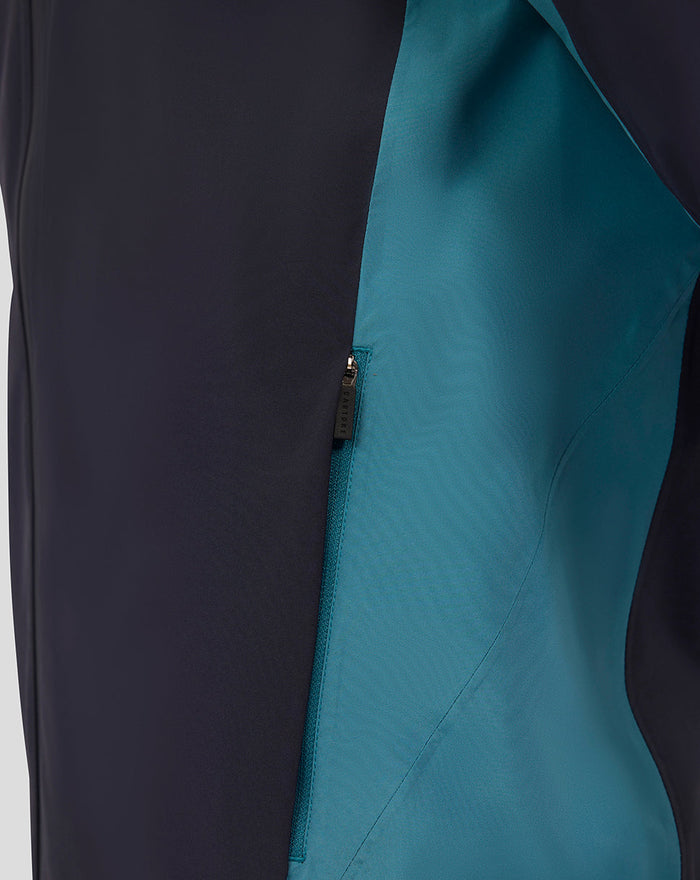 Side view of the navy rain jacket highlighting teal color block panels and a vertical zip.