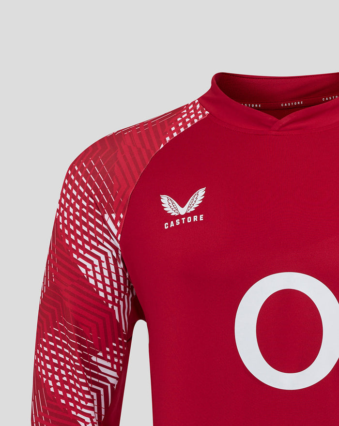 Close up of red England Rugby pre match top showing rose crest on chest and geometric patterned sleeves with O2 branding