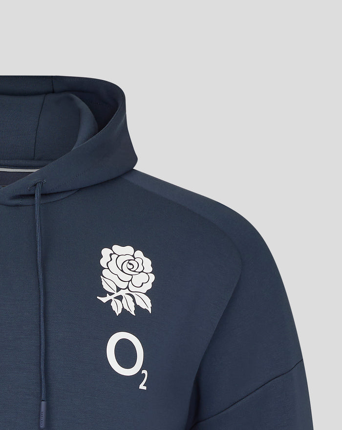Back view of the navy Travel Overhead Hoodie with the hood up and a large white rose graphic on the upper back