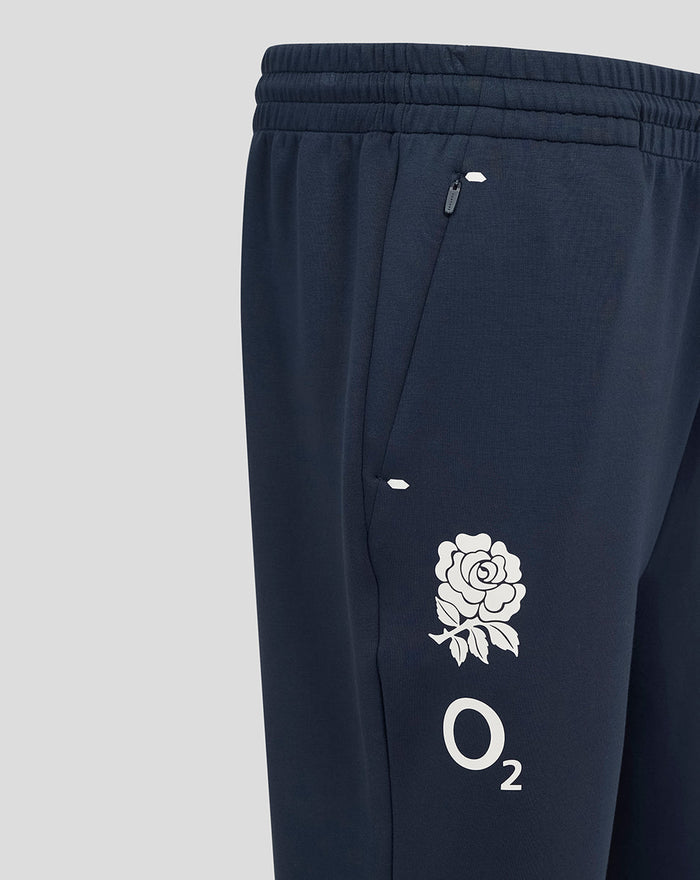 Close-up of navy travel knit pant side zip pocket with O2 rose logo on the leg