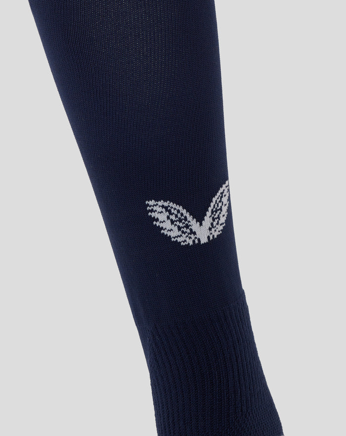 Close up of navy England rugby sock fabric with white Castore logo embroidered on the back leg.