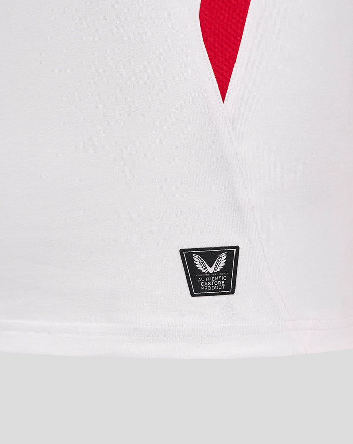 Hem area of white England rugby shirt with a small badge indicating authentic Castore product