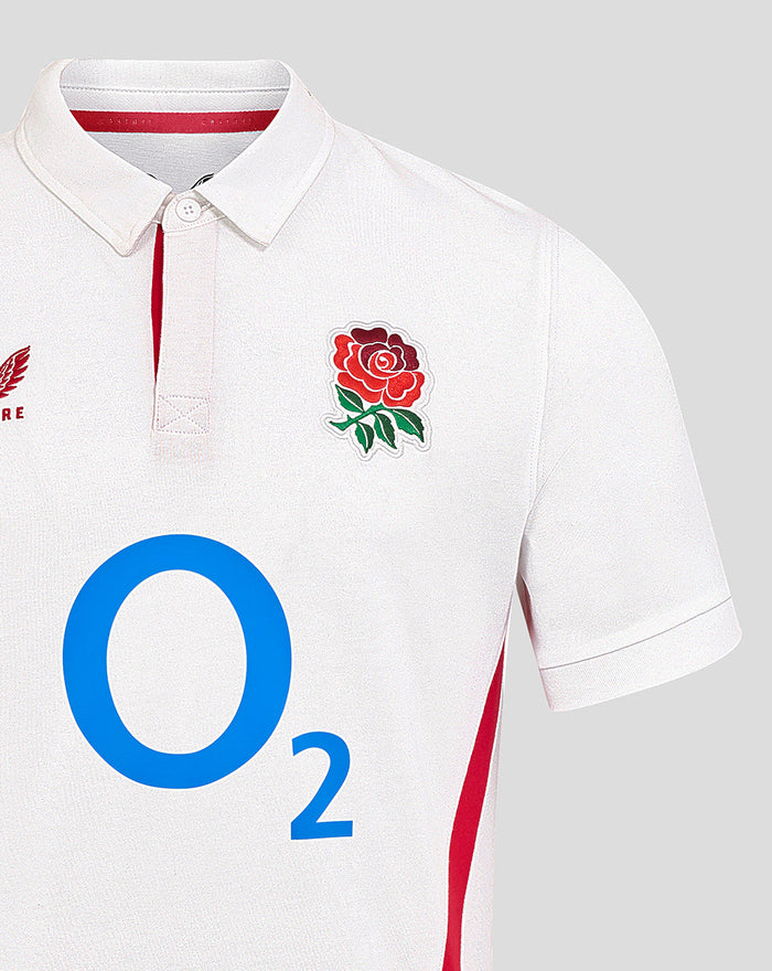 Close-up of white England rugby shirt showing rose crest on left chest and large O2 graphic across the front