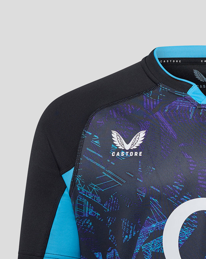 Close up of chest area showing Castore logo and rose crest on a navy England rugby jersey with turquoise trim.