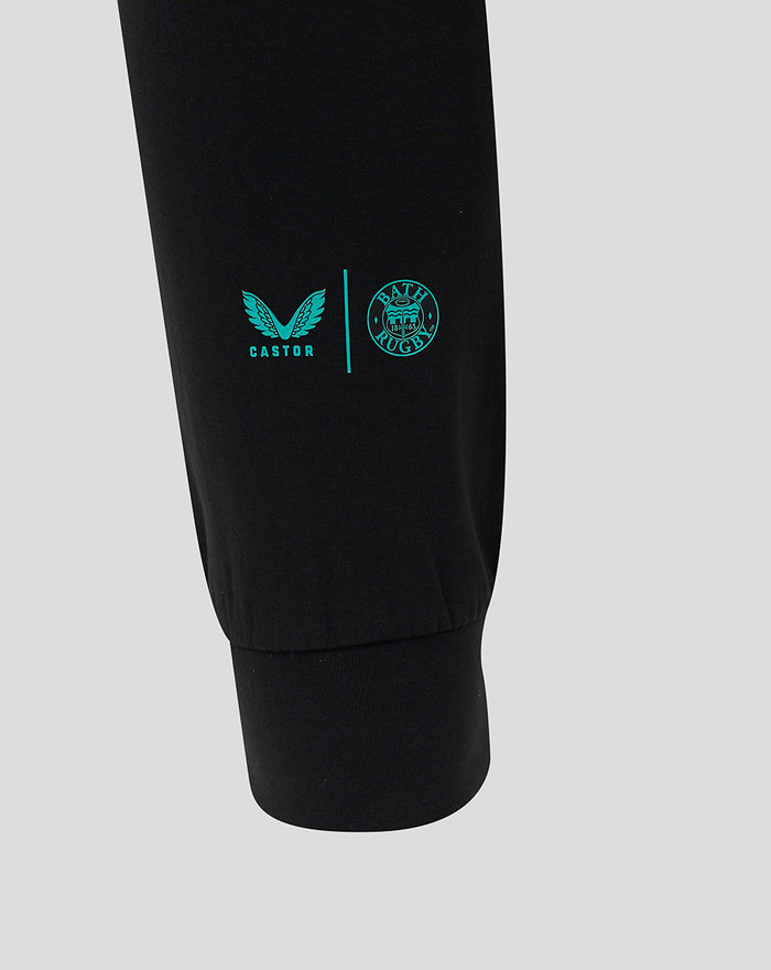 Close-up of black Bath Rugby Travel Pant leg with turquoise Castore and Bath Rugby logos near the cuff