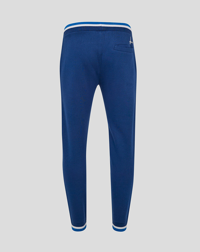 Back view of navy joggers with a back pocket and striped cuffs at the ankles.