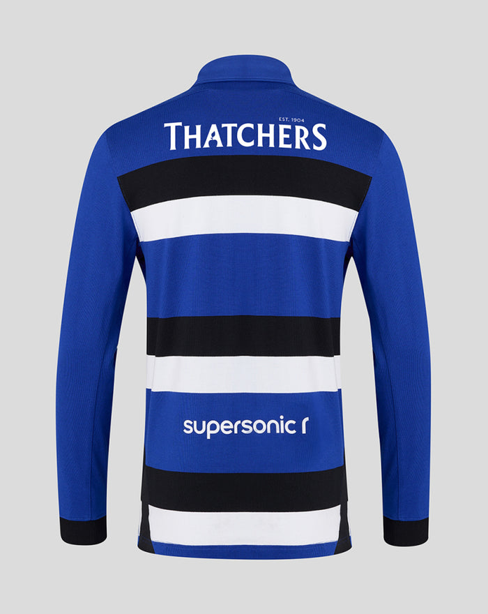 Back view of blue Bath Rugby home shirt with Thatchers branding on the upper back and bold black and white horizontal stripes