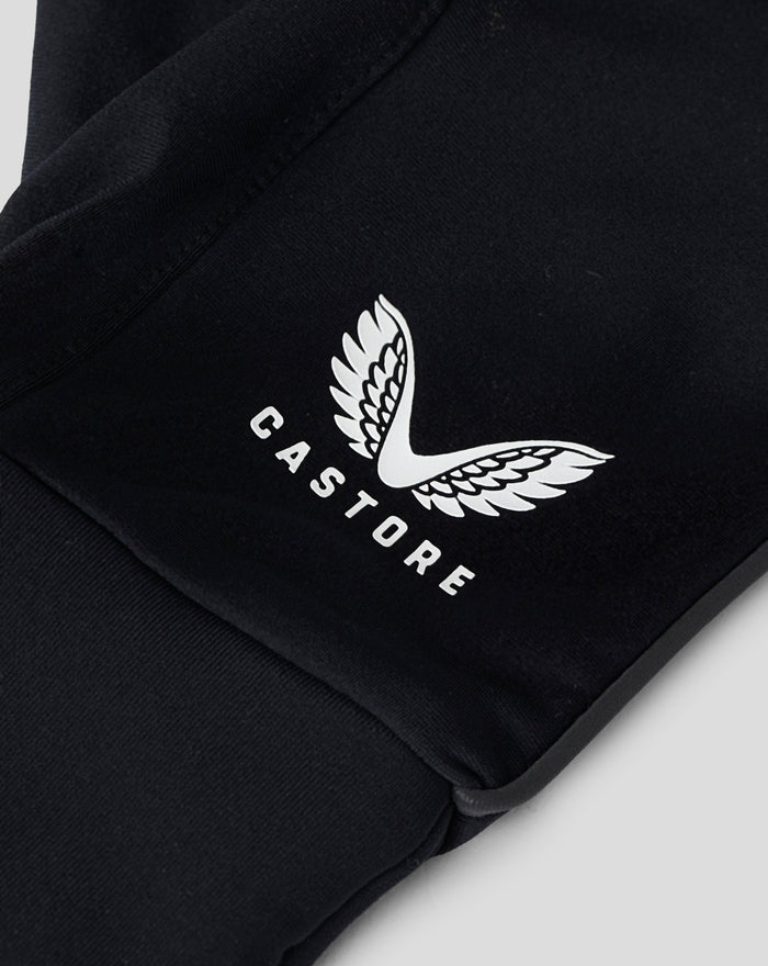 Close up of black glove fabric with a white wing emblem