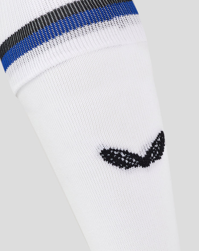 Detail of white away sock showing blue and black stripe band and Castore logo at ankle