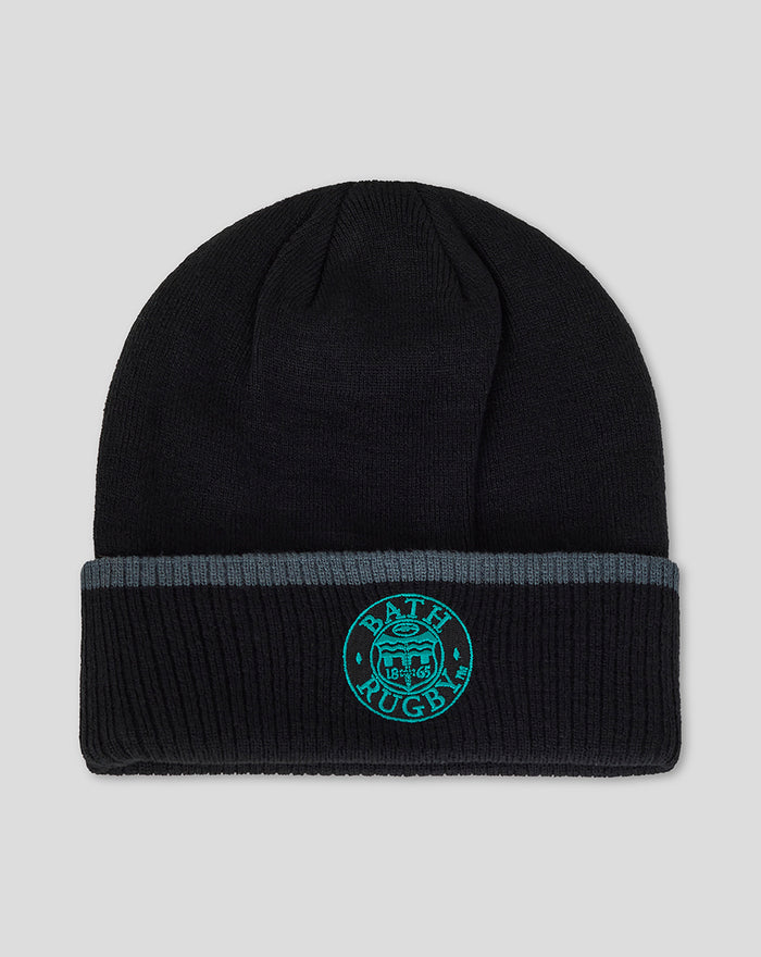 Black Castore beanie with teal wing emblem on the folded cuff.