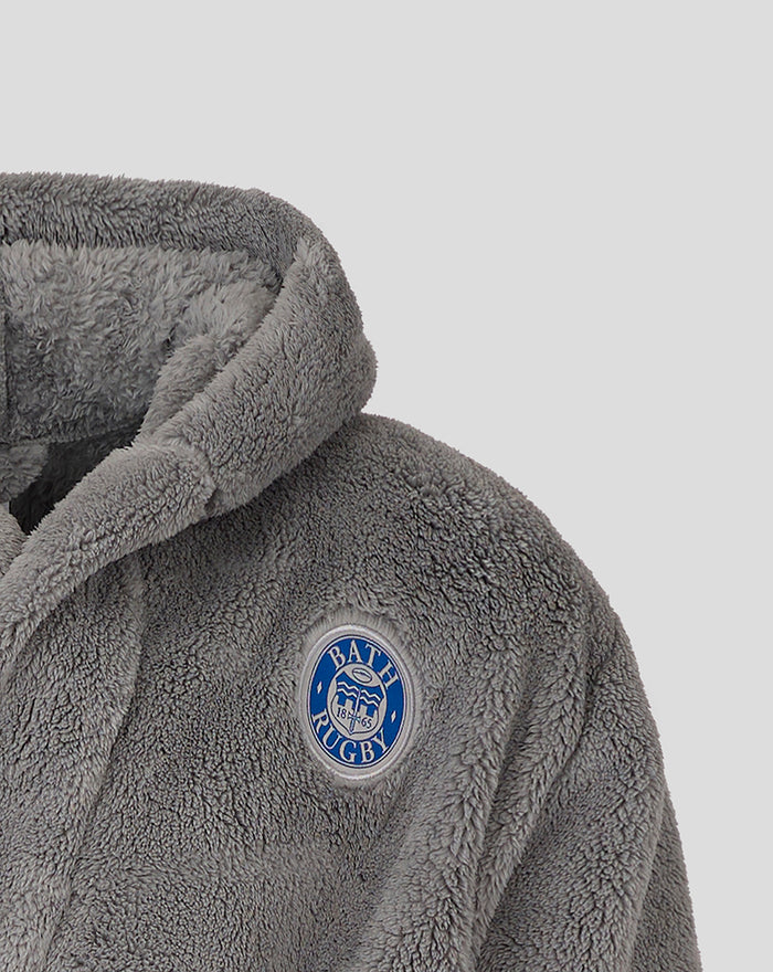 Close up of a gray plush infant dressing gown with Bath Rugby crest badge on the chest